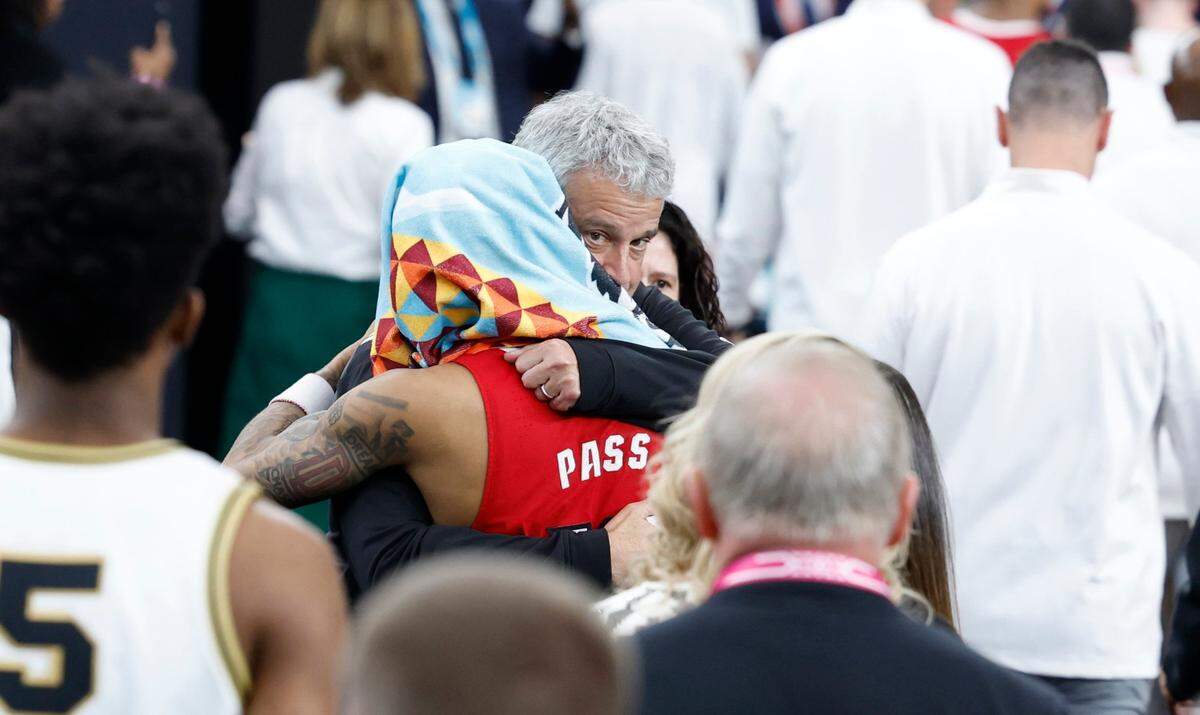N.C. State athletics director Boo Corrigan hugs Breon Pass (10) after Purdue’s 63-50 victory over N.C. State in the NCAA Tournament national semifinals at State Farm Stadium in Glendale, Ariz., Saturday, April 6, 2024.