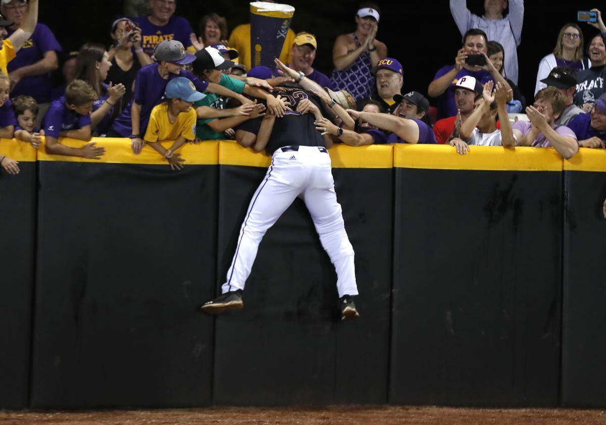 ECU coach Cliff Godwin celebrates with fans after East Carolina’s 12-3 victory over Campbell to win the Greenville Regional at Clark-LeClair Stadium in Greenville, N.C., Monday, June 3, 2019.