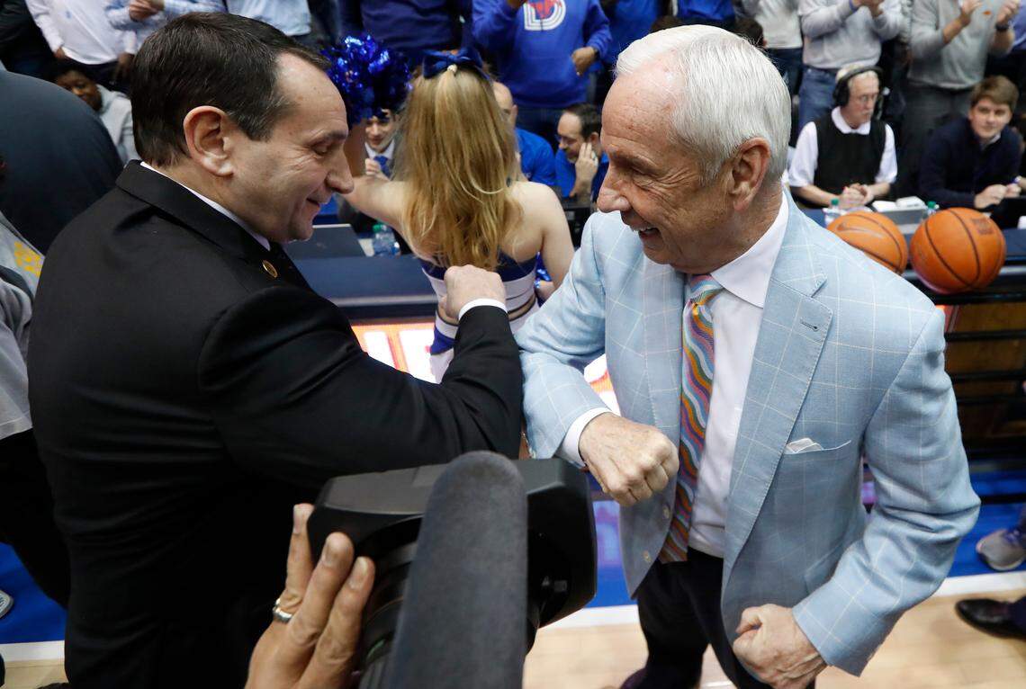 Duke head coach Mike Krzyzewski and UNC head coach Roy Williams bump arms as they greet each other before the North Carolina Tar Heels' game against the Duke Blue Devils at Cameron Indoor Stadium in Durham, N.C., Saturday, March 7, 2020.