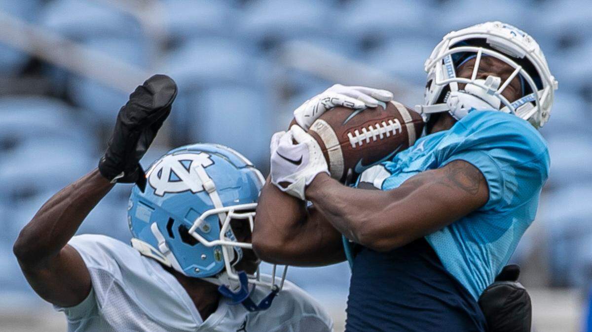 North Carolina wide receiver Devontez Walker (9) pulls in a pass from quarterback Drake Maye over defensive back Marcus Allen (29) during a scrimmage at the Tar Heels’ open practice on Saturday, March 25, 2023 at Kenan Stadium in Chapel Hill. N.C.