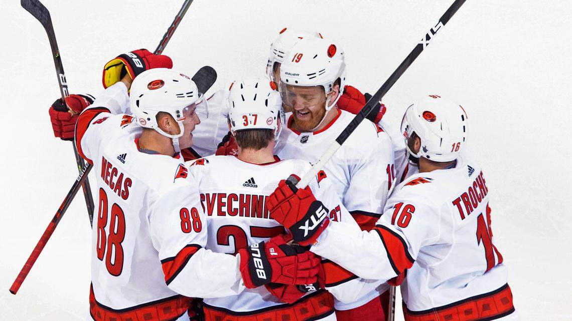 Carolina Hurricanes’ Dougie Hamilton (19) celebrates his goal against the Boston Bruins with teammates Martin Necas (88), Andrei Svechnikov (37) and Vincent Trocheck (16) during the third period of an NHL Eastern Conference Stanley Cup hockey playoff game in Toronto, Thursday, Aug. 13, 2020. (Chris Young/The Canadian Press via AP)