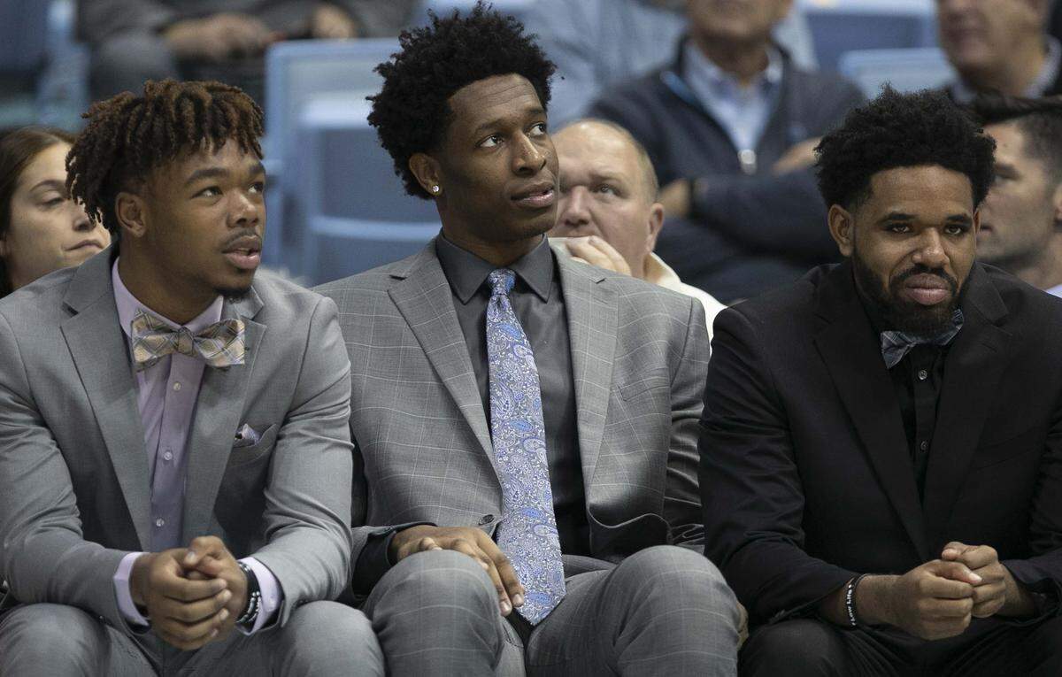 North Carolina players Anthony Harris (0), Sterling Manley (21) and Jeremiah Francis (13) did not play against Winston-Salem State in the Tar Heels’ exhibition game as they recover from injuries on Friday, November 1, 2019 at the Smith Center in Chapel Hill, N.C.