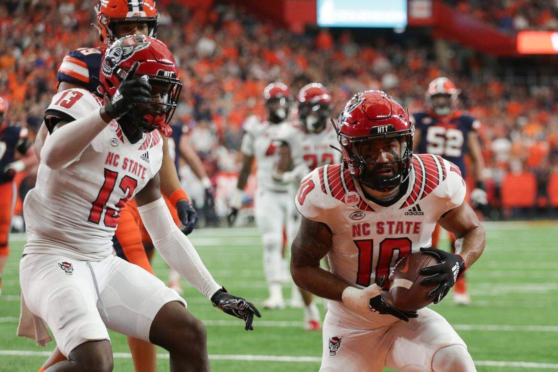 North Carolina State safety Tanner Ingle (10) and defensive back Tyler Baker-Williams (13) celebrate after an interception by Ingle during the first half of an NCAA college football game against Syracuse, Saturday, Oct. 15, 2022, in Syracuse, N.Y.