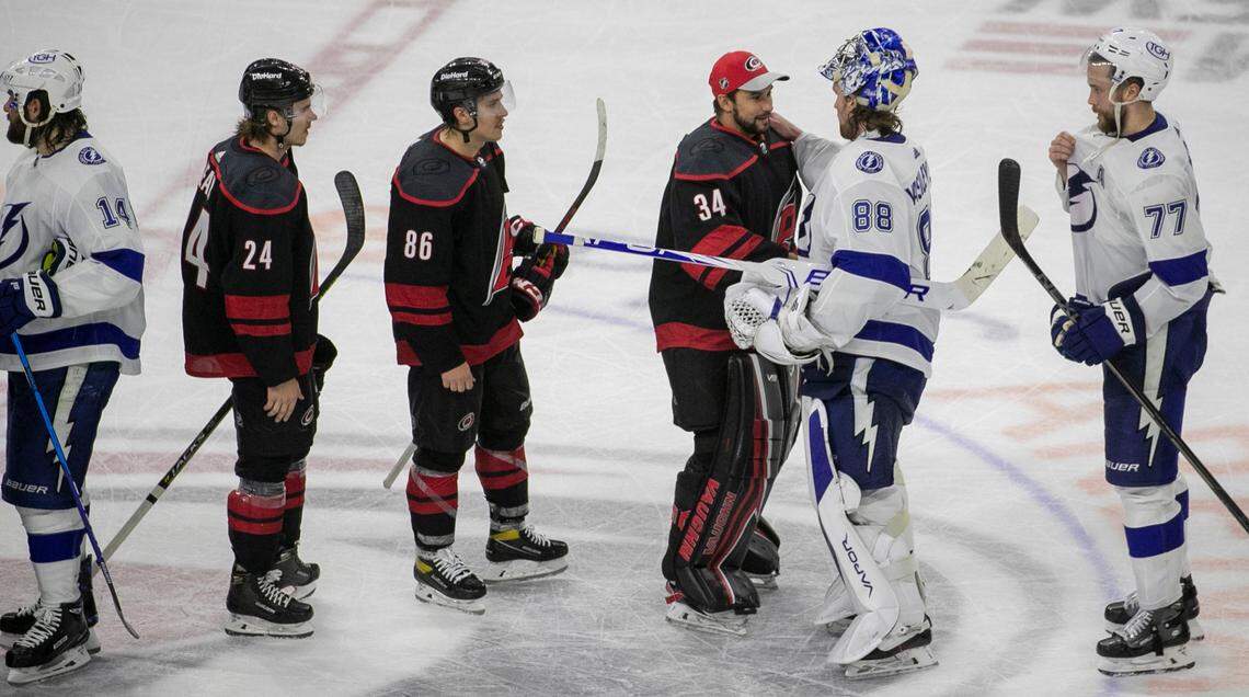 Carolina Hurricanes’ goalie Petr Mrazek (34) shakes hands with Tampa Bay goalie Andrei Vasilevskiy (88) after the Lightning clinched their series against the Hurricanes with a 2-0 victory in game five on Tuesday, June 8, 2021 at PNC Arena in Raleigh, N.C.