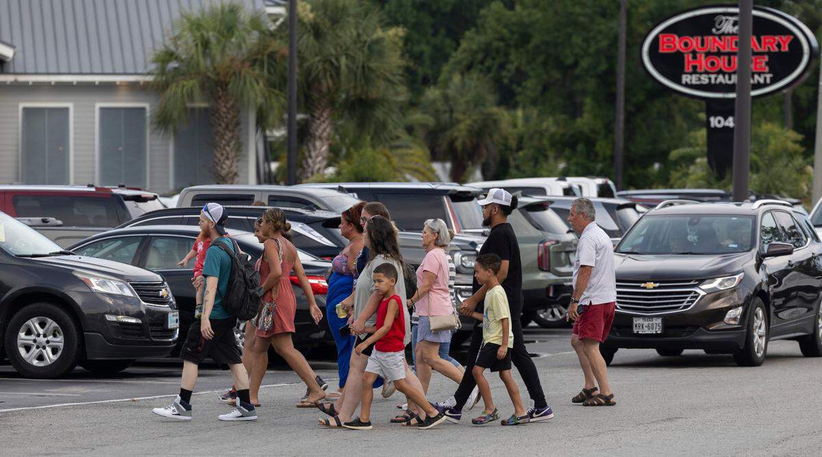 Vacationeers and visitors to Calabash, N.C. cross River Road, to shop at Callahan’s or visit any one of the many restaurants that line the street on Thursday, June 27, 2024 in Calabash, N.C.
