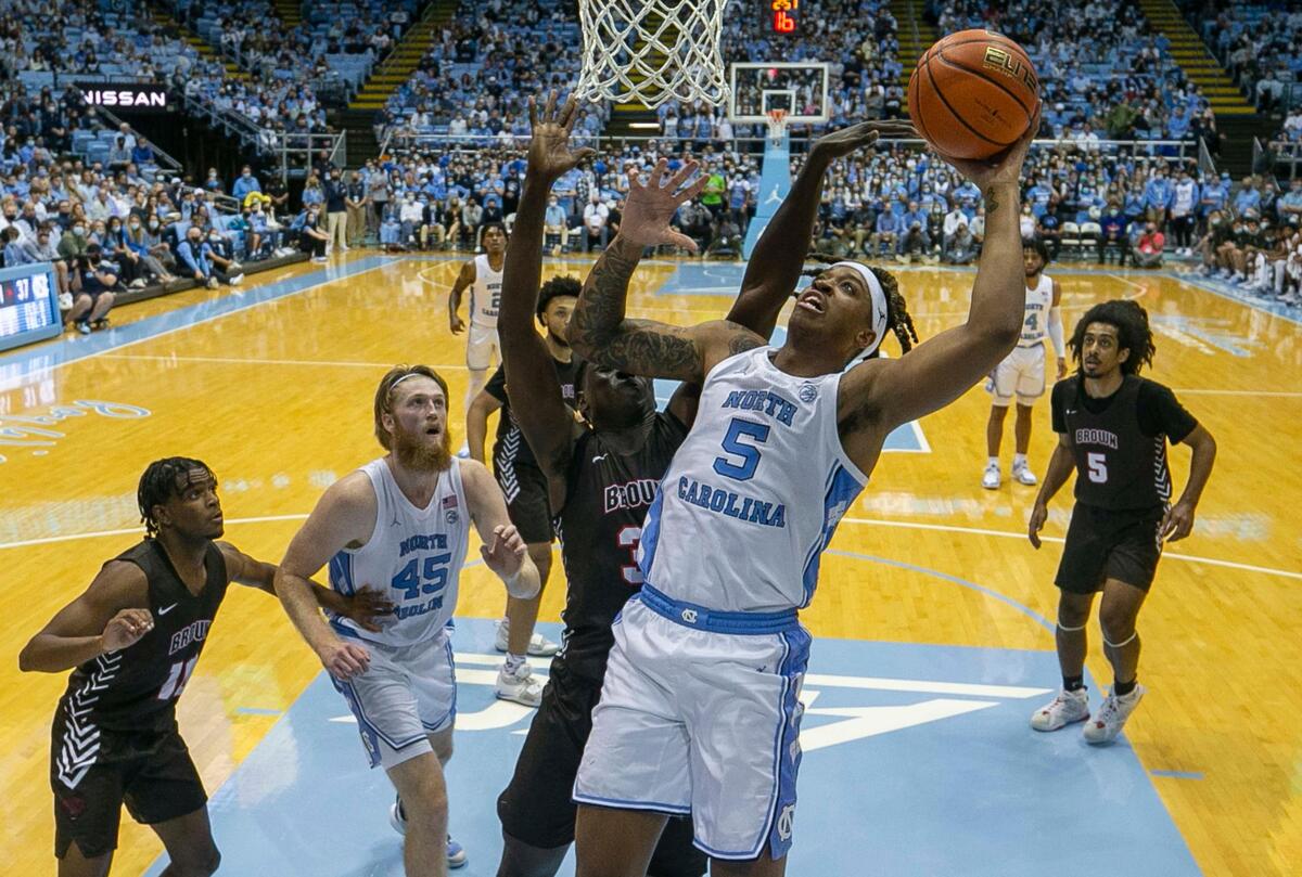 North Carolina’s Armando Bacot (5) muscles his way to the basket against Brown’s Nana Owusu-Anane (31) during the first half on Friday, November 12, 2021 at the Smith Center in Chapel Hill, N.C. Bacot scored 22 points in the Tar Heel’s 94-87 victory.