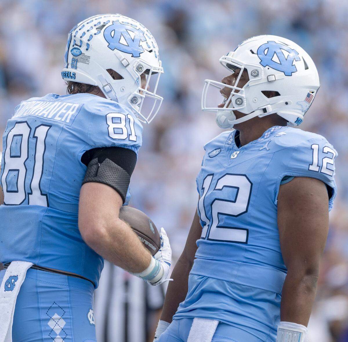 North Carolina quarterback Jacolby Criswell (12) congratulates tight end John Copenhaver (81) after a 35-yard pass reception for a touchdown in the first quarter against James Madison on Saturday, September 21, 2024 at Kenan Stadium in Chapel Hill, N.C.
