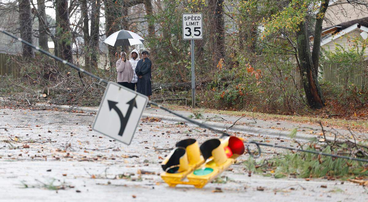 A storm knocked down limbs and traffic lights at Timber Drive and Woodland Road in Garner, N.C., Sunday, Dec. 10, 2023.