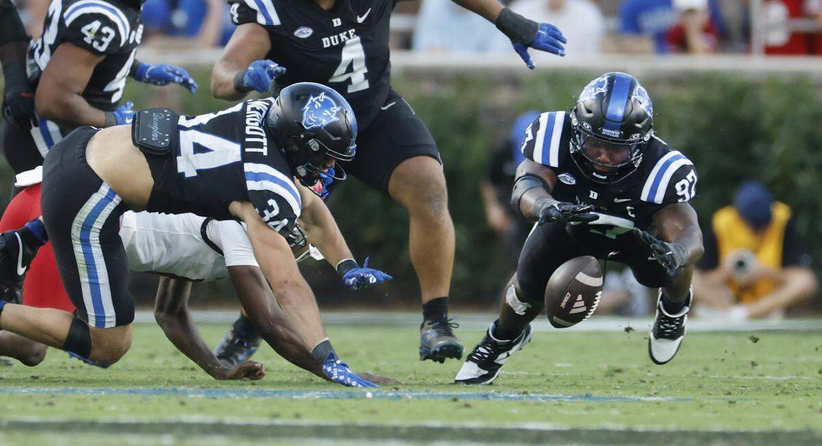 Duke defensive end Wesley Williams (97) dives on a fumble by N.C. State quarterback CJ Bailey (11) in the fourth quarter of Duke’s 45-33 victory over N.C. State at Wallace Wade Stadium in Durham, N.C., Sat. Sept. 20, 2025
