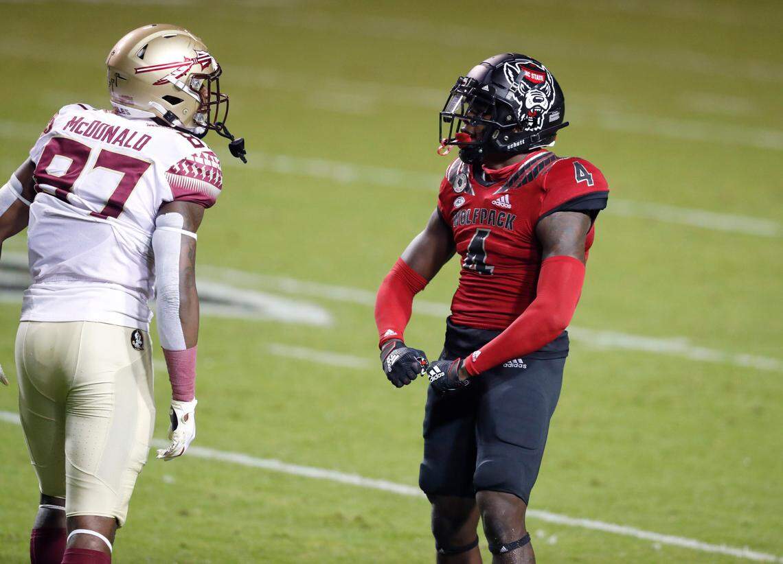 N.C. State cornerback Cecil Powell (4) flexes at Florida State tight end Camren McDonald (87) during the first half of N.C. State’s game against Florida State at Carter-Finley Stadium in Raleigh, N.C., Saturday, Nov. 14, 2020.