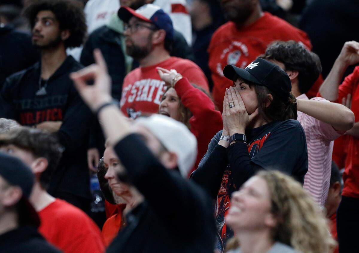 N.C. State fans react late in the second half of the Wolfpack’s 79-73 overtime win against Oakland in the second round of the NCAA Tournament on Saturday, March 23, 2024, at PPG Paints Arena in Pittsburgh, Pa.