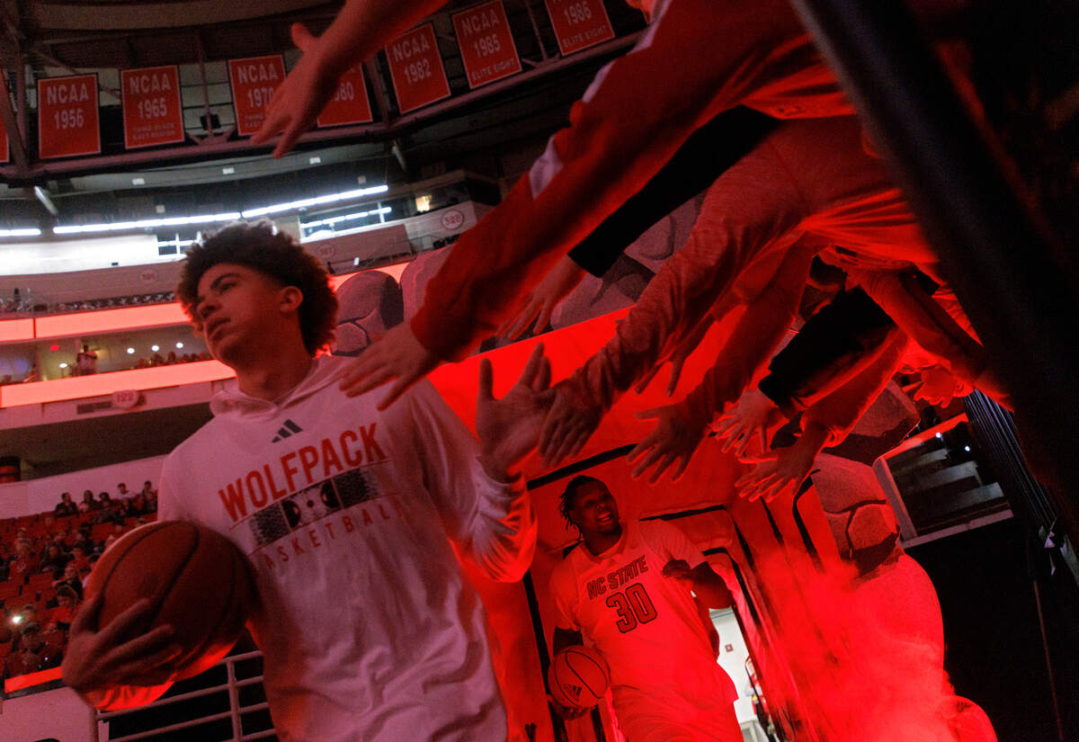 Fans greet the N.C. State men’s basketball team as they take the floor prior to their game against Saint Louis on Wednesday, Dec. 20, 2023, at PNC Arena in Raleigh, N.C.