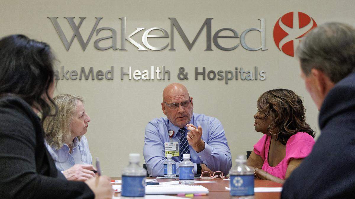 People participate in a group discussion during a community forum held on Tuesday, May 19, 2026, in Raleigh, N.C. about the proposed WakeMed and Atrium merger.
