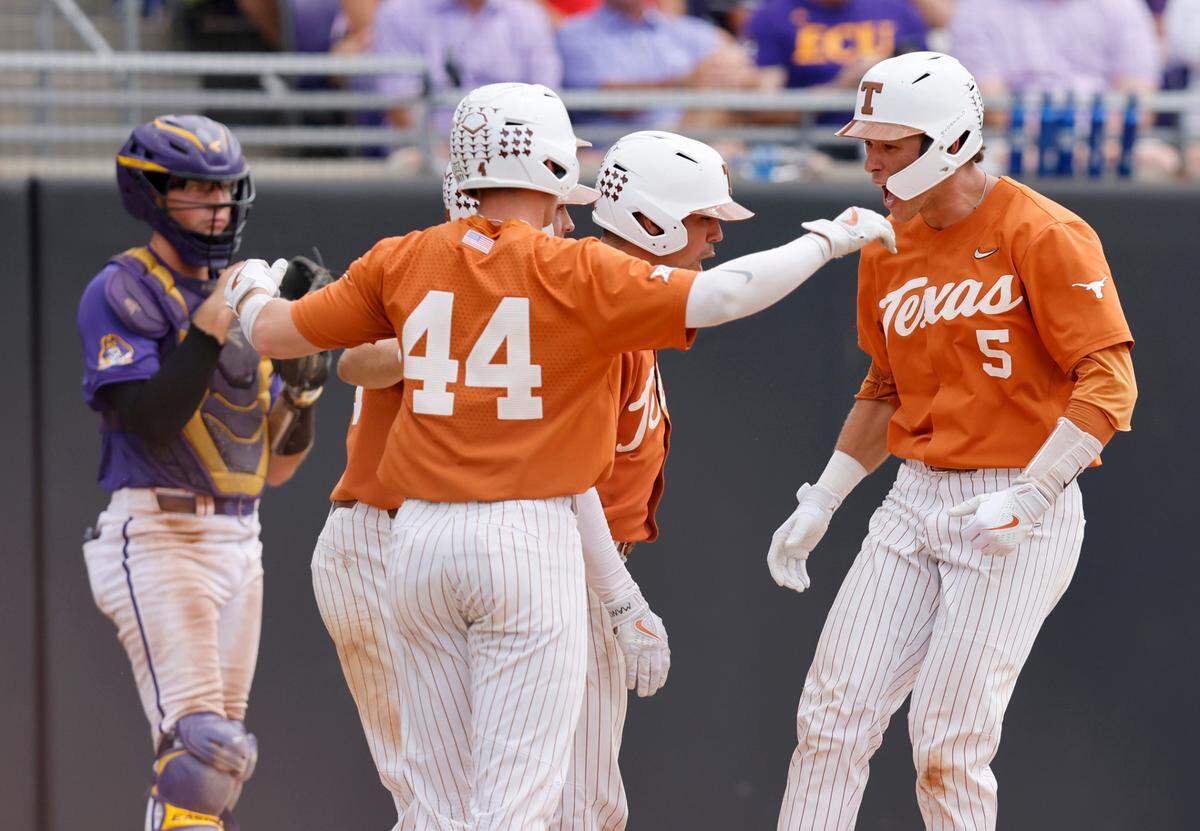 Texas’ Skyler Messinger (5) celebrates with teammates after hitting a three-run homerun in the bottom of the eighth inning during Texas’ 9-8 victory over ECU in the Greenville Super Regional at Clark-LeClair Stadium Saturday, June 11, 2022.