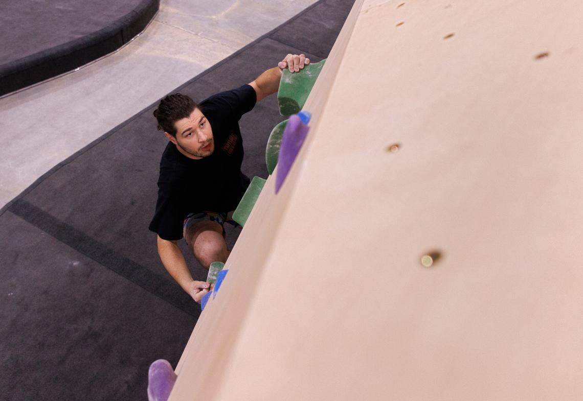 Ian Stein climbs on a bouldering wall at Triangle Rock Club’s new facility in Raleigh’s Salvage Yard on Friday, Sept. 27, 2024.