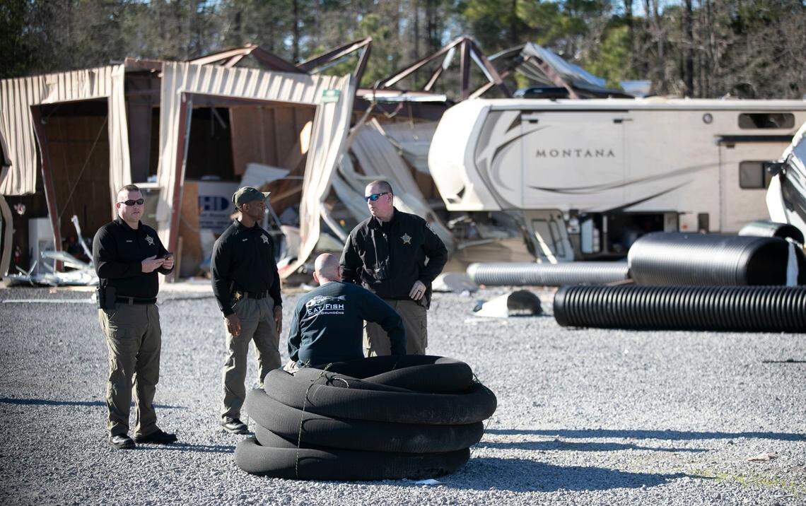 Rich Dobkin, owner of Ocean Ridge Storage Solutions, talks with Brunswick County Deputies after surveying the damage to Dobkins business in Sunset Beach, N.C. on Tuesday, February 16, 2021 after a tornado ripped through the Brunswick County community late Monday night.
