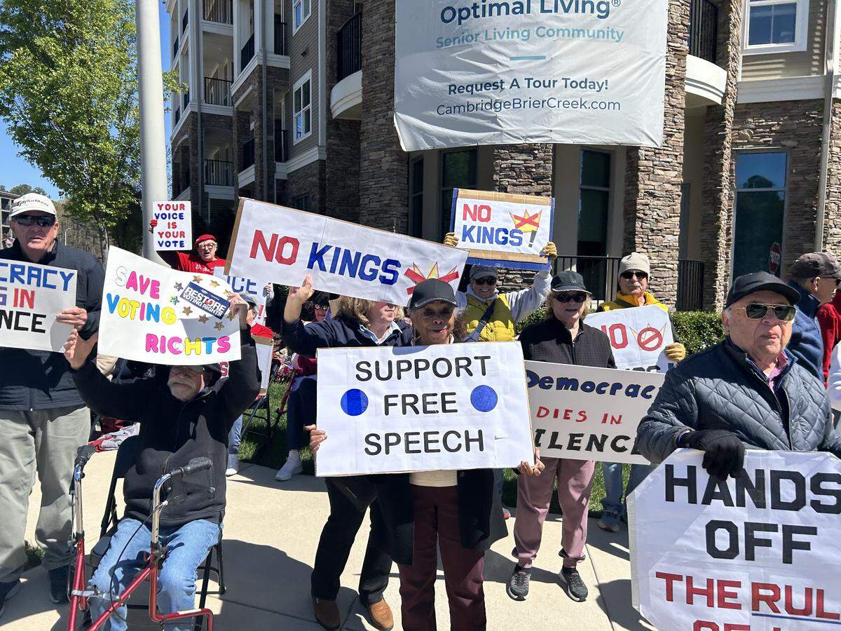 Protesters form a senior citizens No Kings rally outside The Cambridge at Brier Creek Saturday.