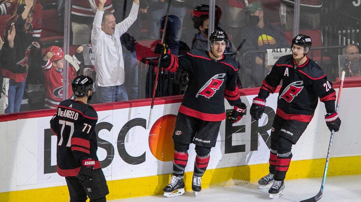 Carolina Hurricanes Tuevo Teravainen (86) celebrates with Tony DeAngelo (77) and Sebastian Aho (20) after scoring on New York Rangers goalie Igor Shesterkin (31) during the second period on Thursday, May 26, 2022 during game five of the Stanley Cup second round at PNC Arena in Raleigh, N.C.