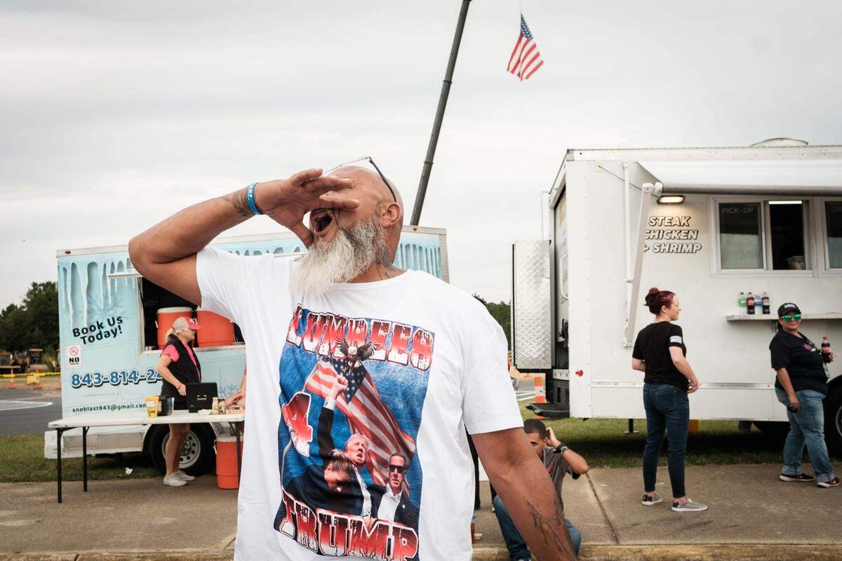 Johnny Locklear yells ‚ÄúLumbees for Trump‚Äù outside a Trump campaign rally at the Crown Arena on Friday, Oct. 4, 2024, in Fayetteville, N.C.
