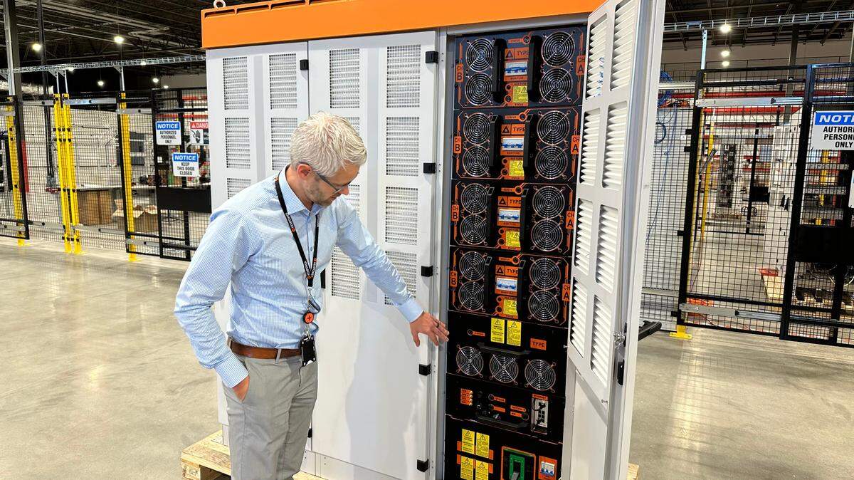 Marcus Suvanto of Kempower shows the inside of a power unit for its electric vehicle charging system at the company’s North American headquarters in Durham. The Finnish company shipped its first charging system made in Durham on Thursday, Dec. 14, to a customer in Edmonton, Canada.