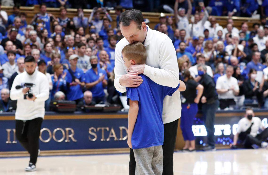 Duke head coach Mike Krzyzewski gives his grandson Caden Frasher a hug after a ceremony honoring Coach K after his final game at Cameron Indoor Stadium in Durham, N.C., Saturday, March 5, 2022.