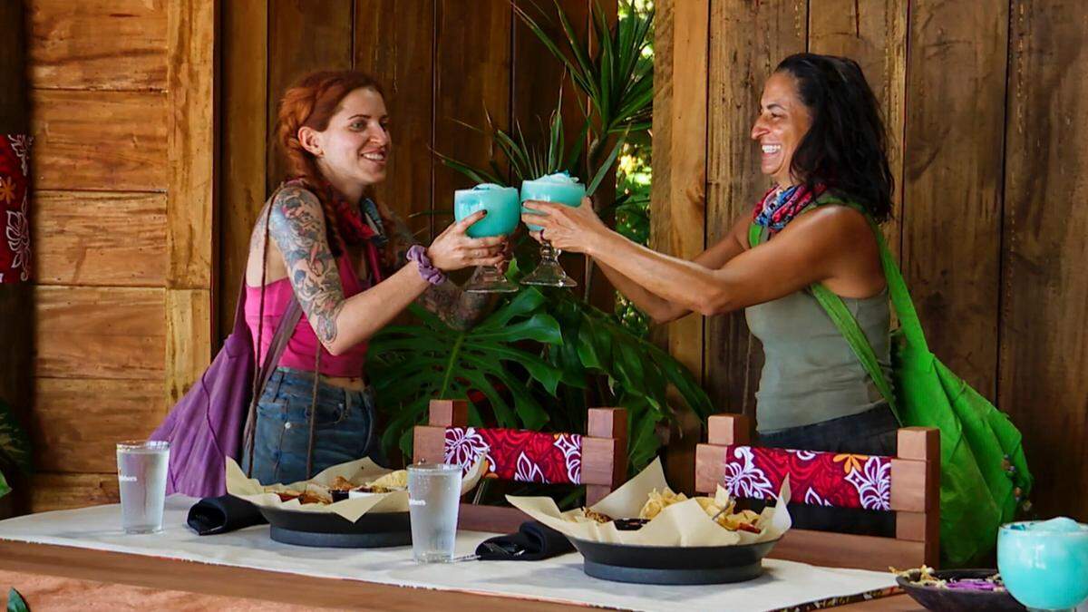 Kenzie Veurink Petty, left, and Maria Gonzalez toast at a reward after a challenge. CBS