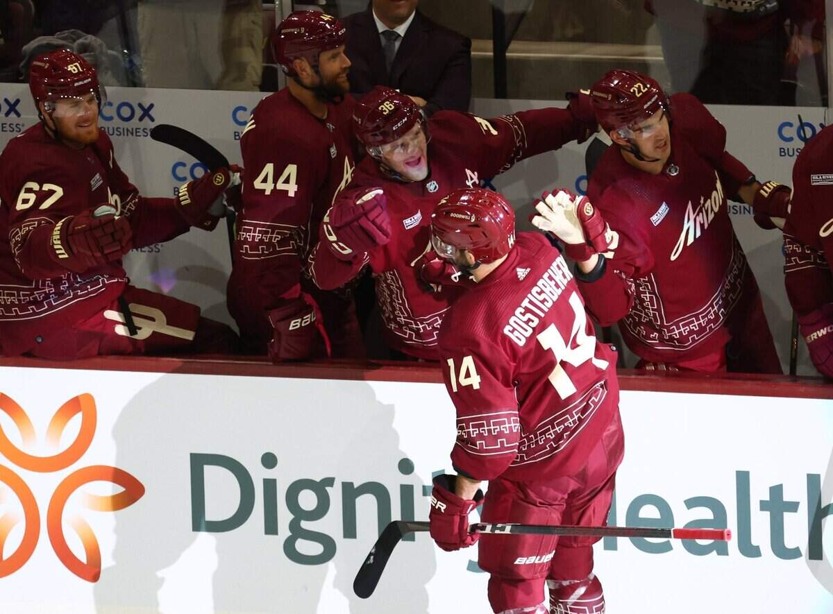 Feb 26, 2023; Tempe, Arizona, USA; Arizona Coyotes defenseman Shayne Gostisbehere (14) celebrates with teammates after scoring a goal against the Nashville Predators in the first period at Mullett Arena. Mandatory Credit: Mark J. Rebilas-USA TODAY Sports