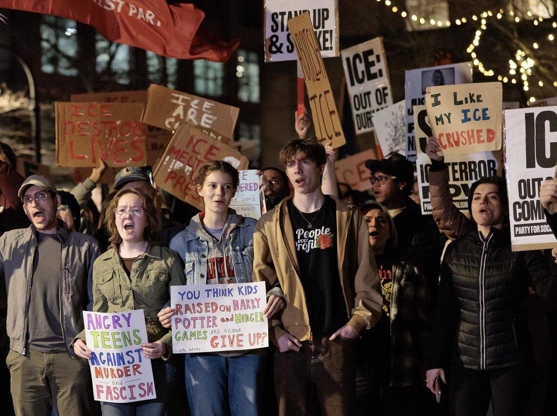 People hold signs during a protest in downtown Durham on Thursday, Jan. 8, 2026, held in response to Wednesday’s fatal shooting of Renee Nicole Good by a federal immigration agent in Minneapolis.