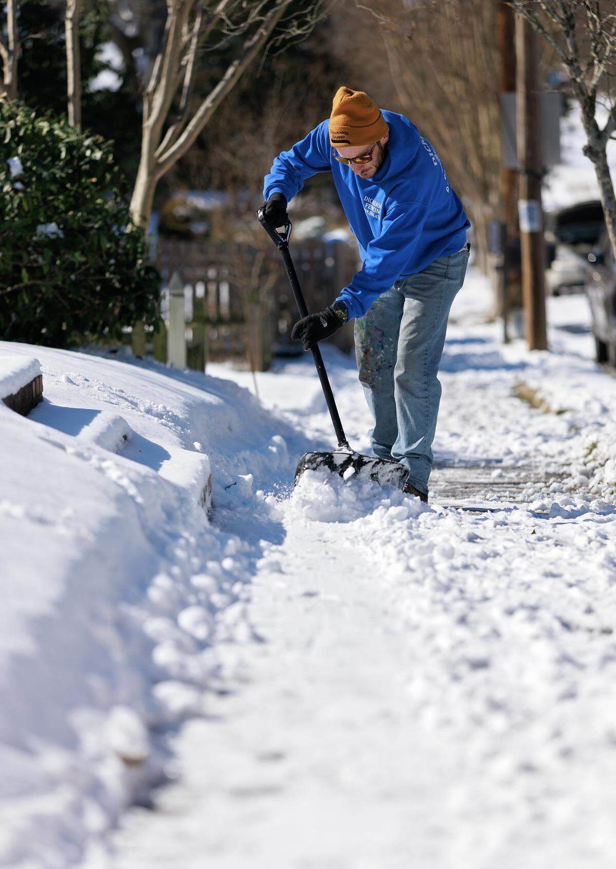Scott Vancil shovels snow from a sidewalk on Sunday, Feb. 1, 2026, in Durham, N.C.