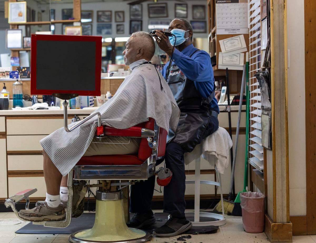 Willie Stevens gets his hair cut by Sylvester White at White’s Barber Shop on Thursday, May 15, 2025, in Raleigh, N.C.
