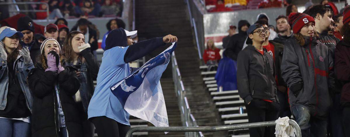 North Carolina fans celebrate during the second half of UNC’s 41-10 victory over N.C. State at Carter-Finley Stadium in Raleigh, N.C., Saturday, November 30, 2019.