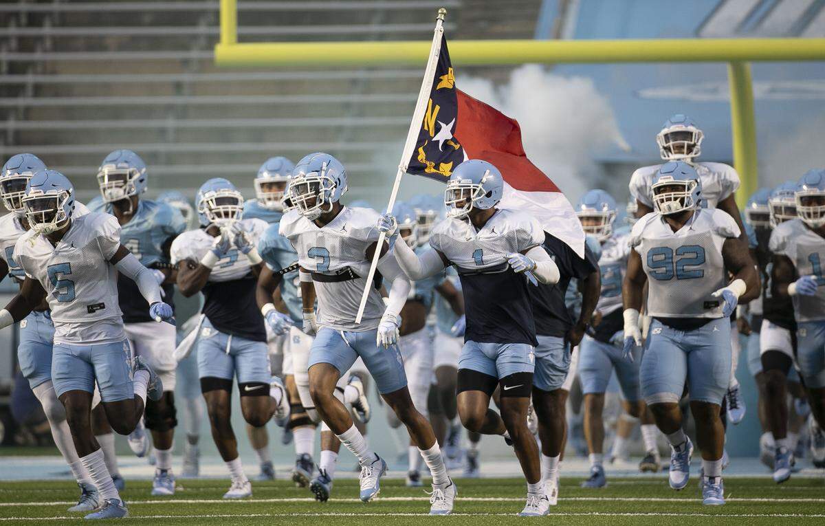 North Carolina senior defensive back Myles Dorn (1) leads his teammate into Kenan Stadium for practice on Monday, August 19, 2019 in Chapel Hill, N.C.