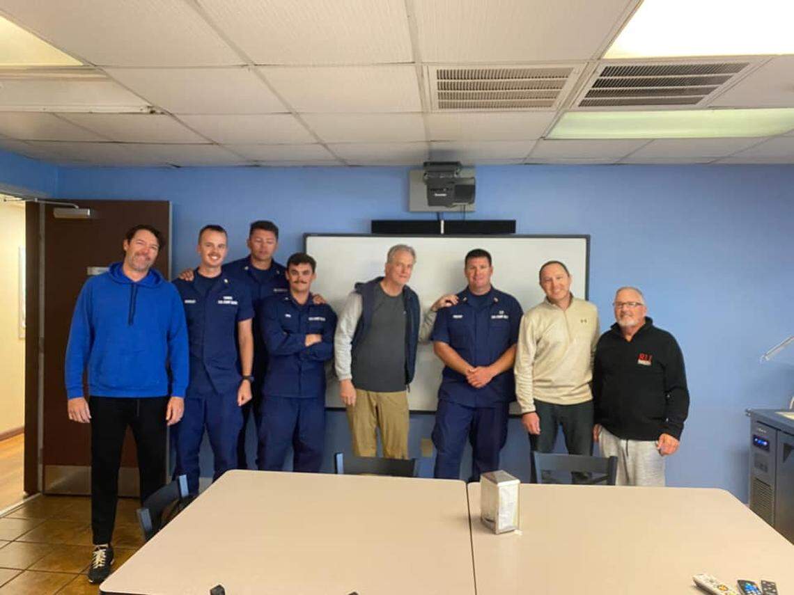 The four boaters posed for a photo with their rescuers at the Coast Guard Station for Oregon Inlet, NC.