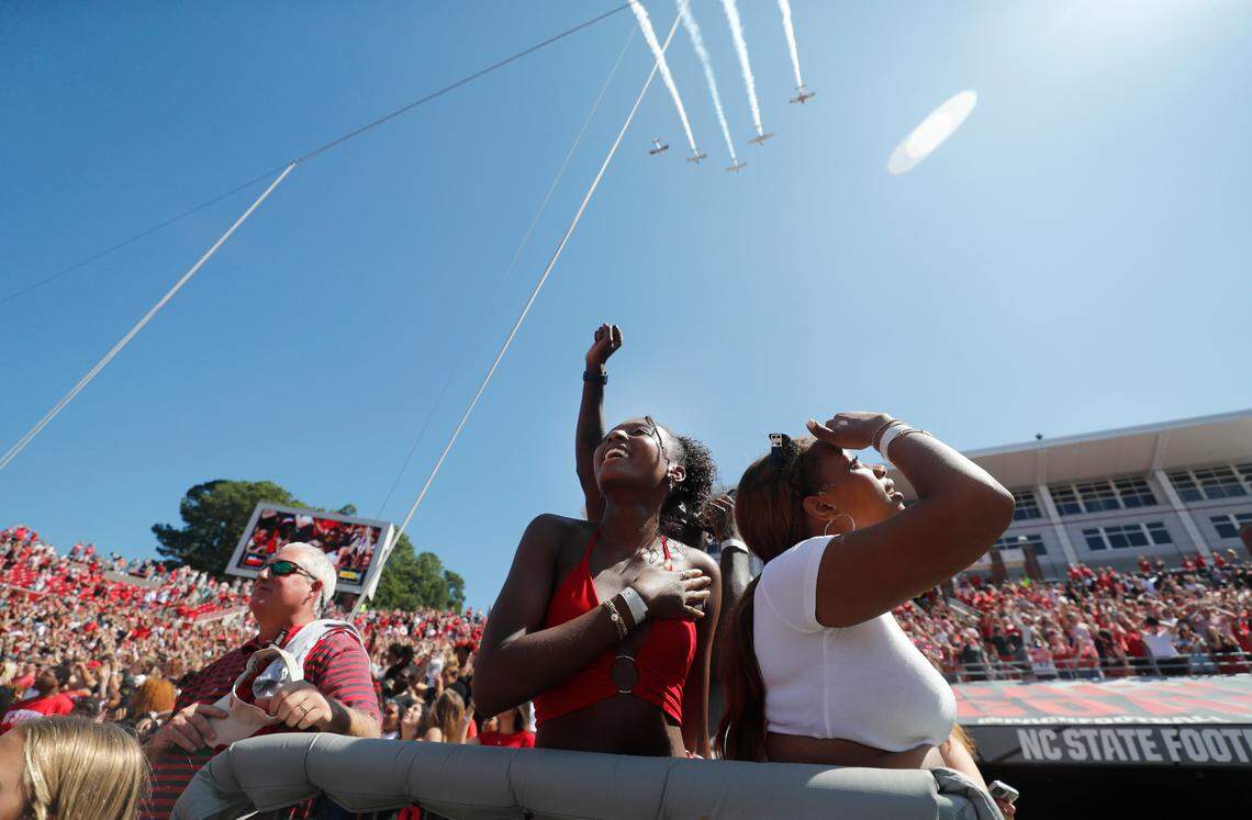 Fans watch as the Bandit Flight Team flies over Carter-Finley Stadium before N.C. State’s game against VMI at Carter-Finley Stadium in Raleigh, N.C., Saturday, Sept. 16, 2023.