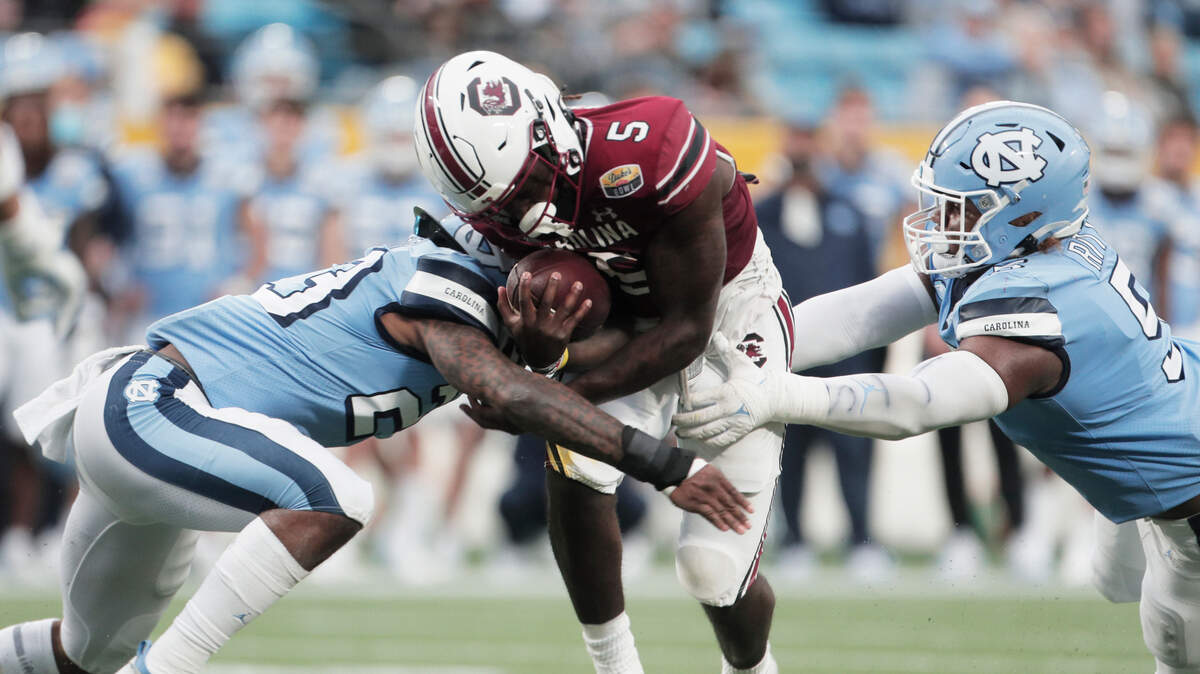 South Carolina Gamecocks wide receiver Dakereon Joyner (5) is tackled by North Carolina’s Power Echols 23 and Jahvaree Ritzie 5 at the Duke’s Mayo Bowl at Bank of America Stadium in Charlotte, North Carolina on Thursday, December 30, 2021.