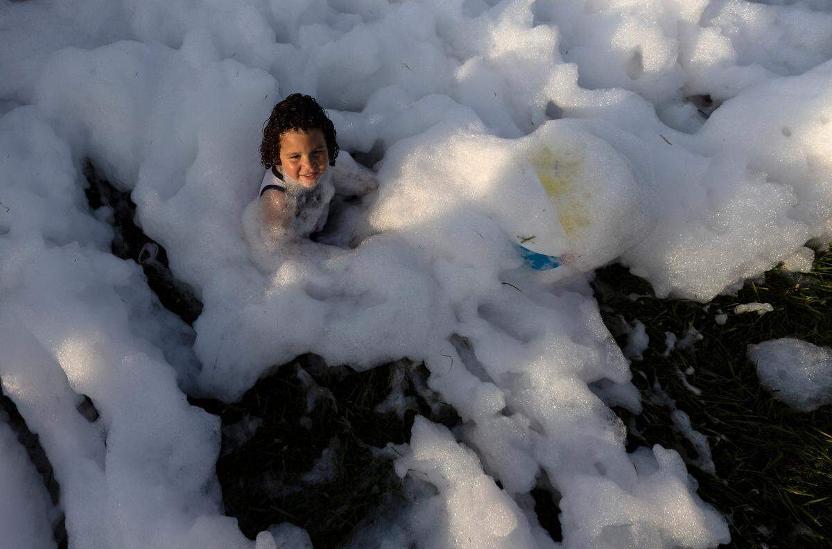 A child plays in a foam pit during an Independence Day celebration at Dorothea Dix Park on Tuesday, July 4, 2023, in Raleigh, N.C.