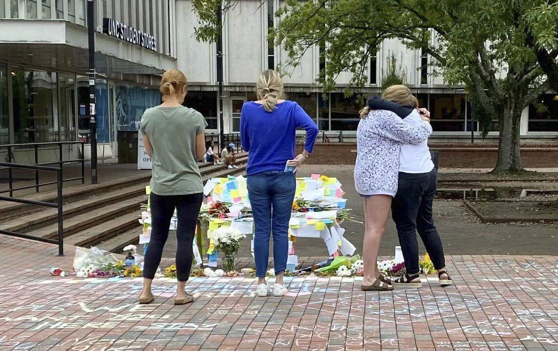 Family members of a UNC student who died Saturday, Oct. 9, 2021, grieve by a memorial to three students who have died this semester.