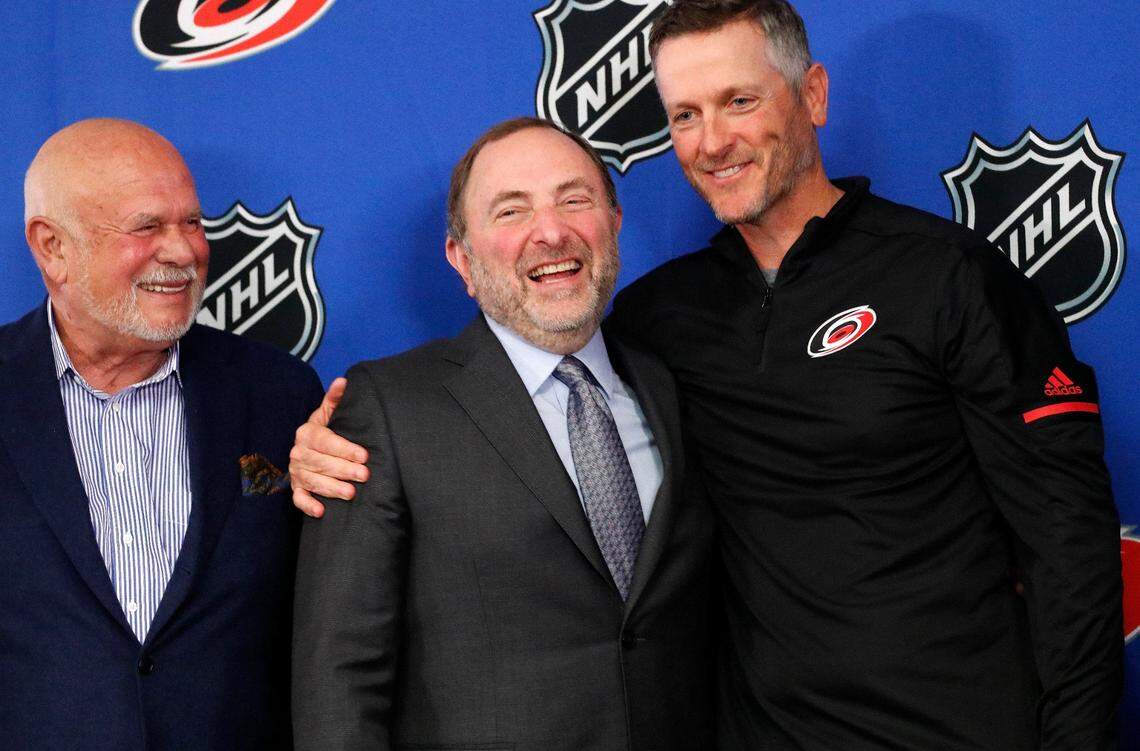 Former majority owner Peter Karmanos, left, NHL commissioner Gary Bettman, center, and Thomas Dundon, new Hurricanes majority owner, laugh together at the end of the press conference where Dundon was announced as the buyer and new majority owner of the Carolina Hurricanes NHL hockey club at PNC Arena in Raleigh, NC, on Jan. 12, 2018.