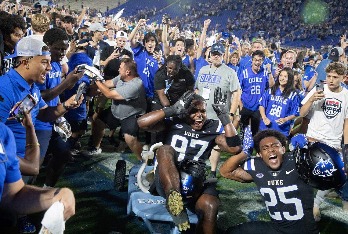 Duke’s Wesley Williams and Al Wooten II celebrate with the Victory Bell after the Blue Devils’ 21-20 win over North Carolina on Saturday, Sept. 28, 2024, at Wallace Wade Stadium in Durham, N.C.