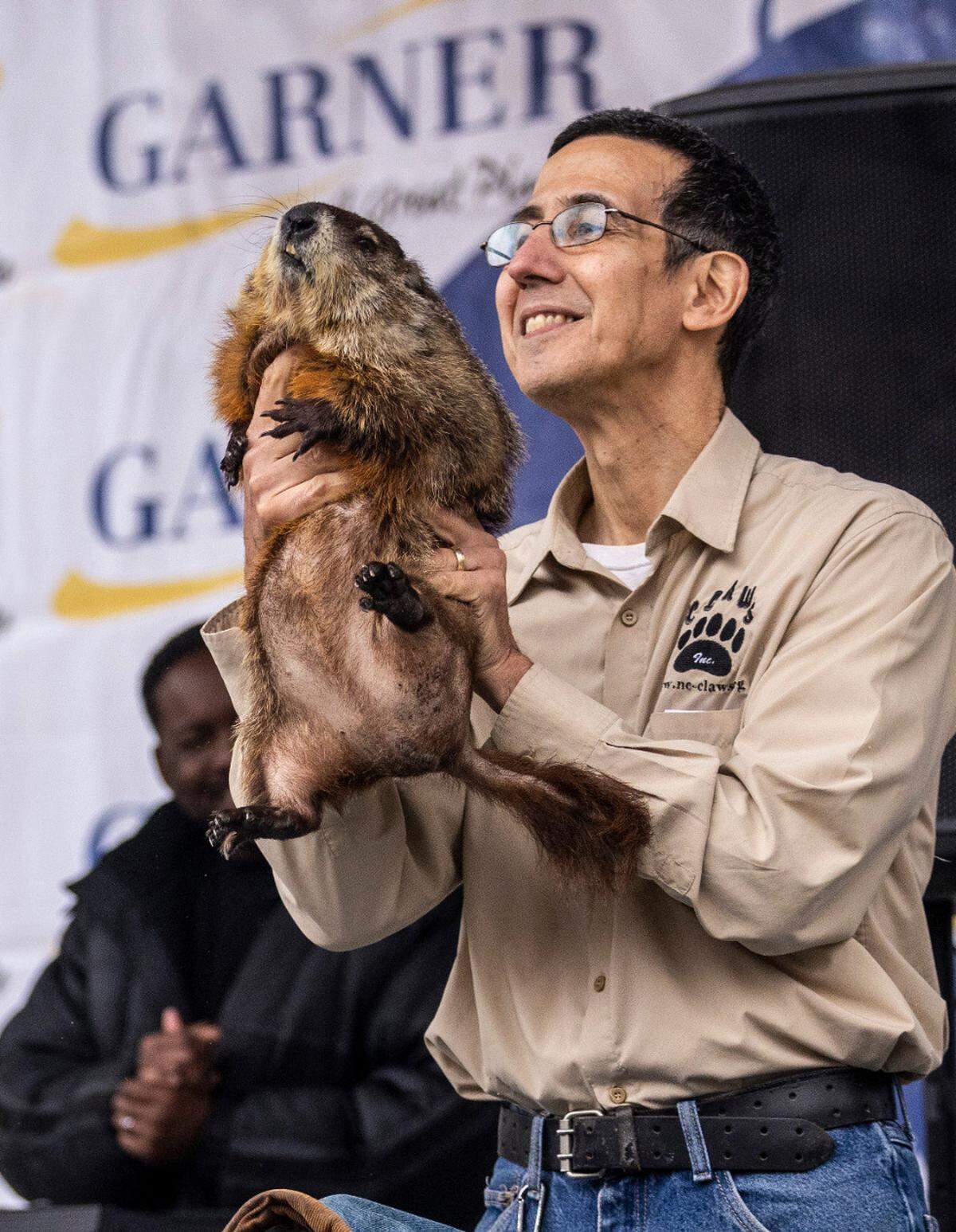 Vincent Mammone of CLAWS Inc. Wildlife Sanctuary holds up a groundhog named “Snerd” after it predicted six more weeks of winter on Feb. 2, 2023.