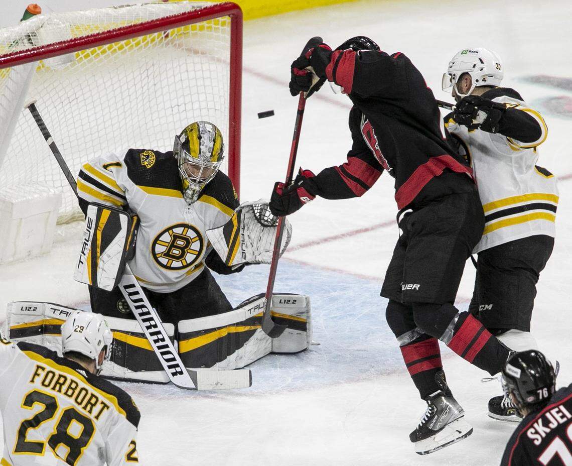 Carolina Hurricanes Jesper Fast (71) deflects a shot on Boston Bruins goalie Jeremy Swayman (1) in the second period on Tuesday, May 10, 2022 during game five of their Stanley Cup first round series at PNC Arena in Raleigh, N.C
