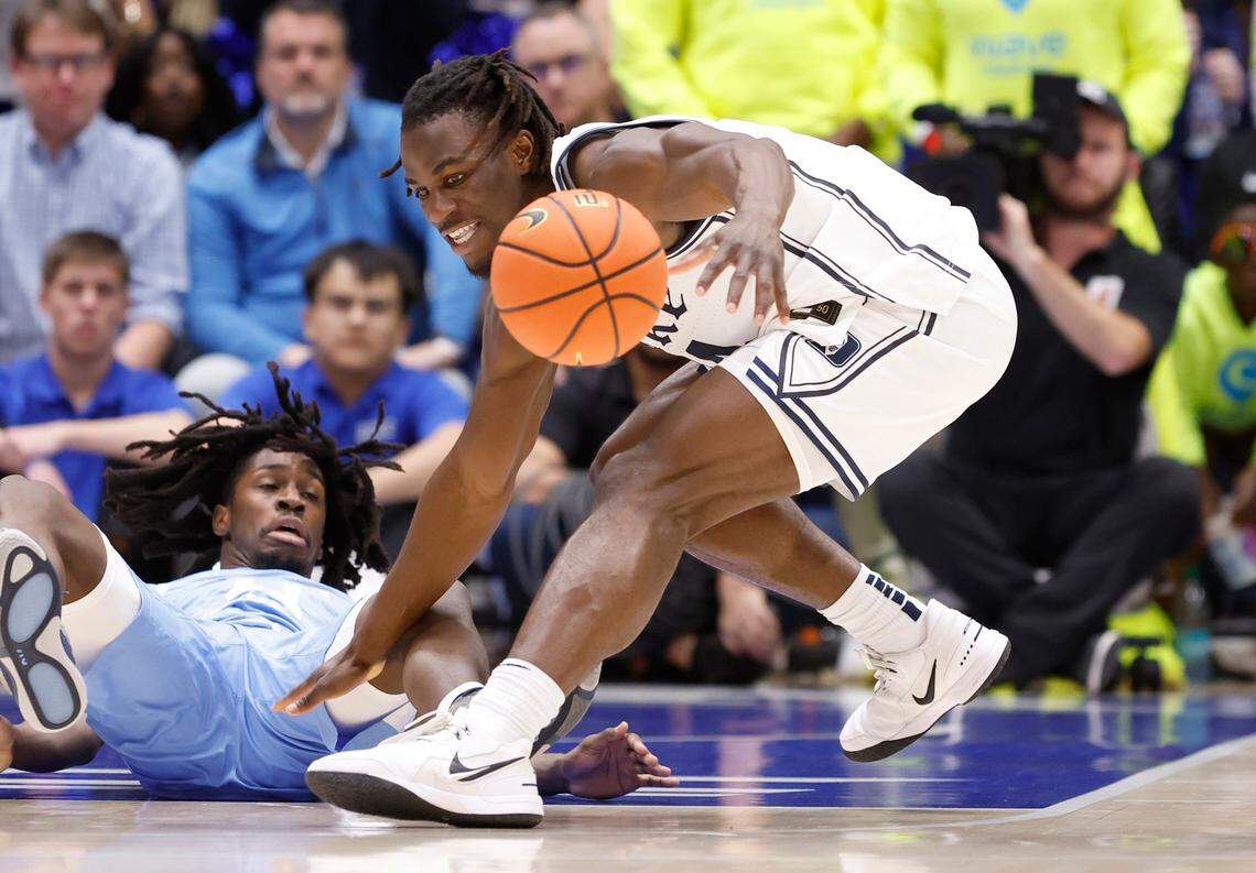 Duke’s Sion James (14) keeps the ball from North Carolina’s Ian Jackson (11) during the first half of Duke’s game against UNC at Cameron Indoor Stadium in Durham, N.C., Saturday, Feb. 1, 2025.