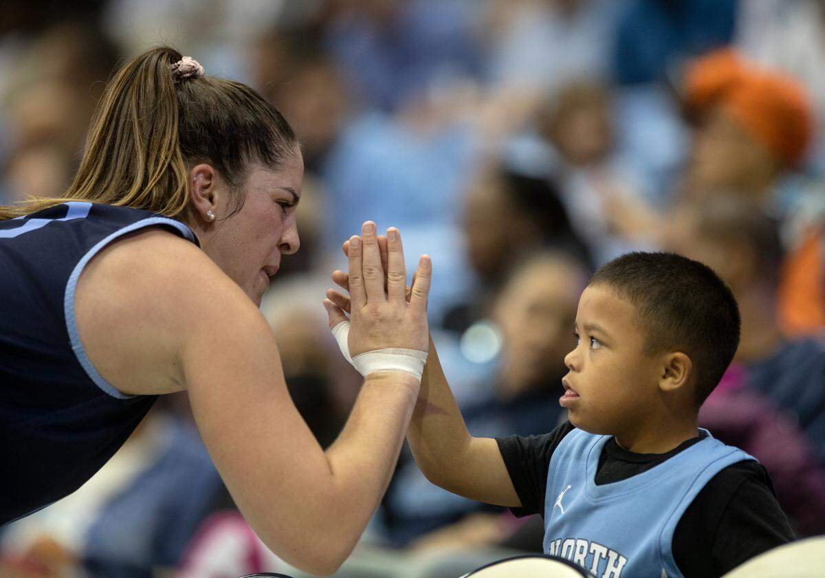 North Carolina’s Eva Hodgson high-fives Kendall Geer, 7, during “Live Action with Carolina Basketball” at the Dean E. Smith Center on Friday, Oct. 7, 2022, in Chapel Hill, N.C.