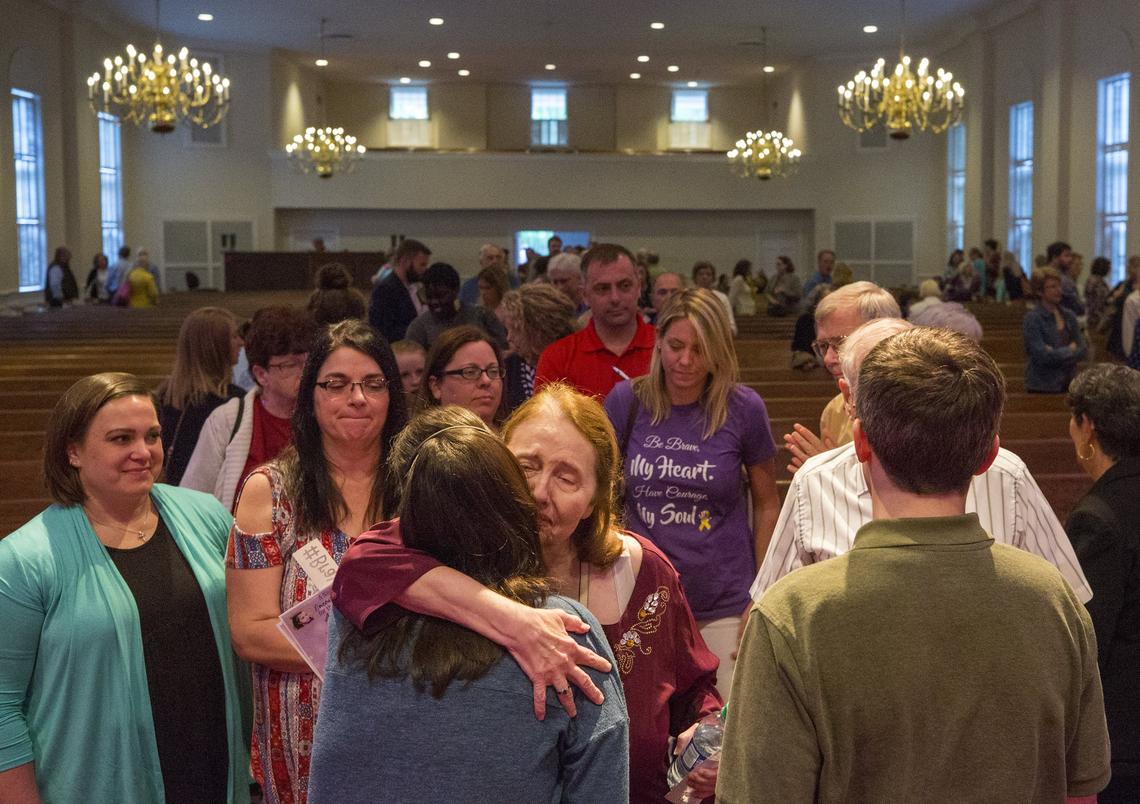 Emily, left, and Andy Neill receive hugs from their congregation after a "Night of Encouragement" at Bay Leaf Baptist Church in Raleigh on Sunday, April 29.