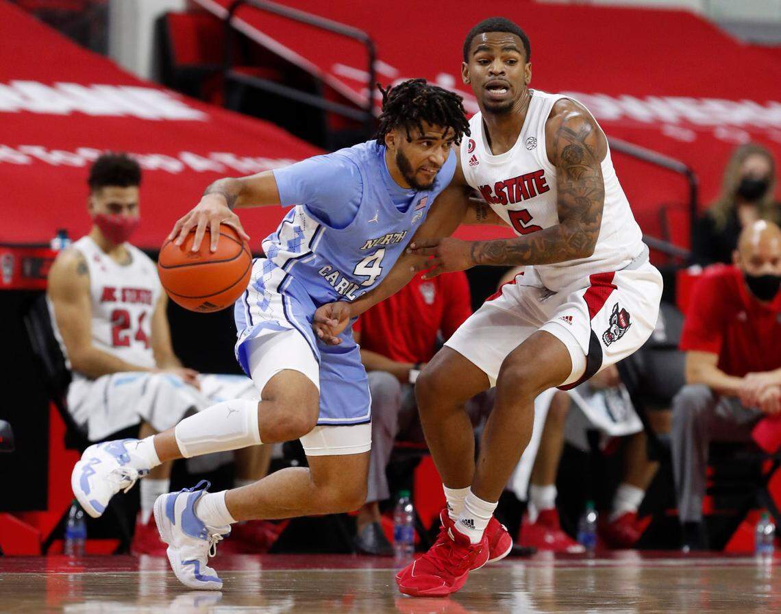 North Carolina’s R.J. Davis (4) drives around N.C. State’s Thomas Allen (5) during the first half of N.C. State’s game against UNC at PNC Arena in Raleigh, N.C., Tuesday, December 22, 2020.
