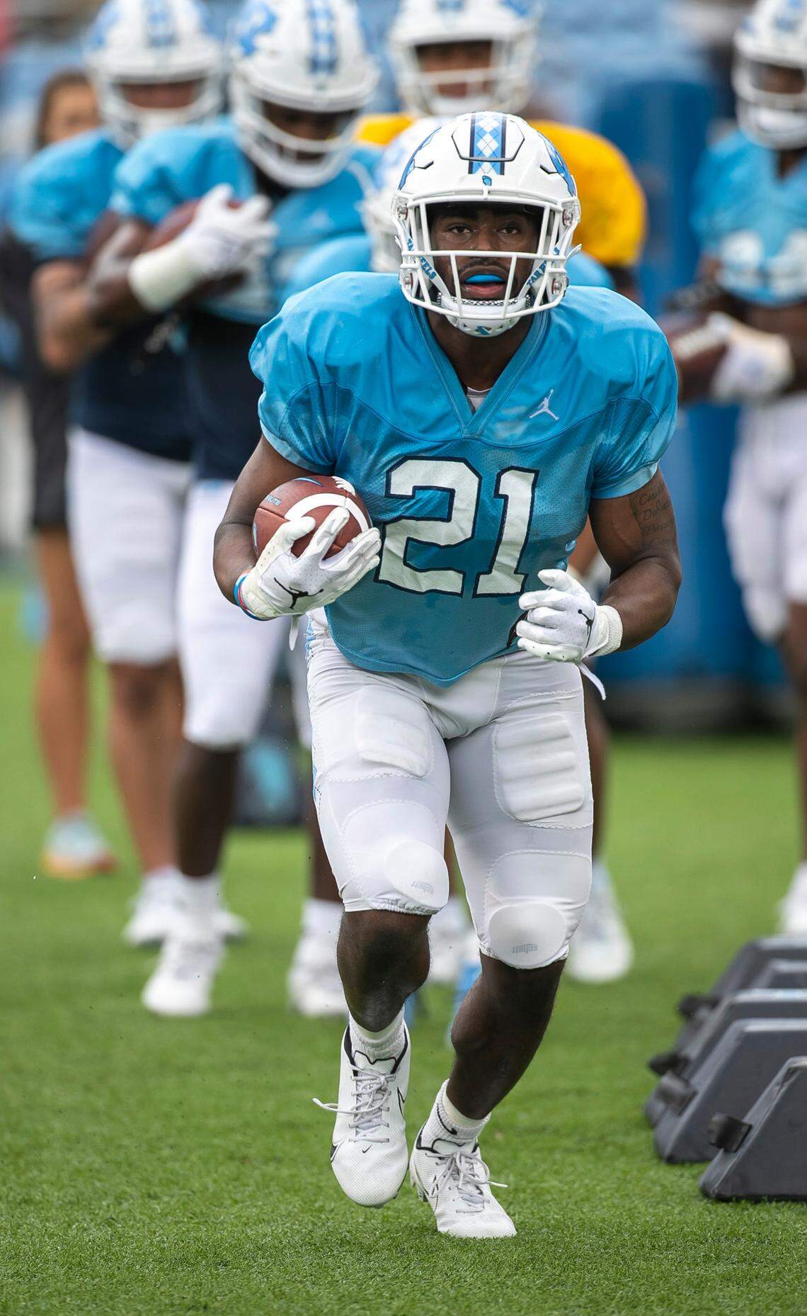 North Carolina running back Elijah Green (21) runs through a drill during at the Tar Heels’ open practice on Saturday, March 25, 2023 at Kenan Stadium in Chapel Hill. N.C.