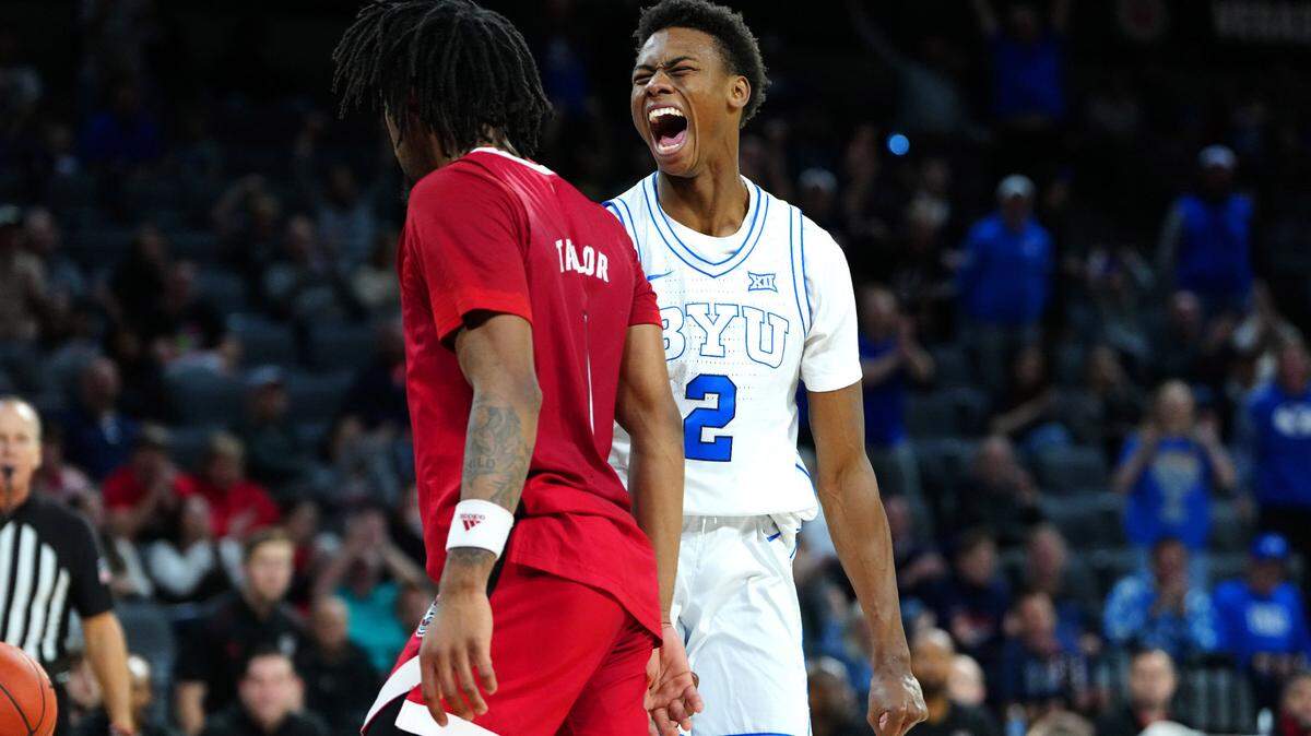 Nov 24, 2023; Las Vegas, NV, USA; Brigham Young Cougars guard Jaxson Robinson (2) shouts towards North Carolina State Wolfpack guard Jayden Taylor (1) during the first half at Michelob ULTRA Arena.