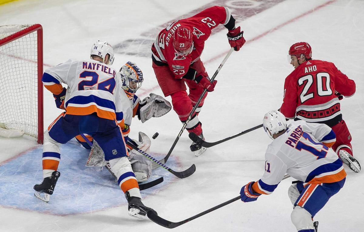The Carolina Hurricanes Stefan Noesen (23) works to score on New York Islanders goalie Ilya Sorokin (30) in the third period during Game 2 of their Stanley Cup series on Wednesday, April 19, 2023 at PNC Arena in Raleigh, N.C.