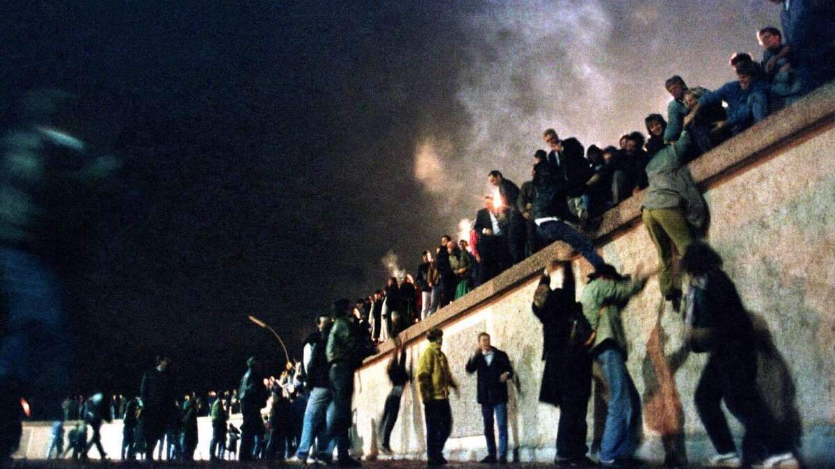 Germans celebrate the fall of the Berlin Wall on Nov. 9, 1989. (AP photo)