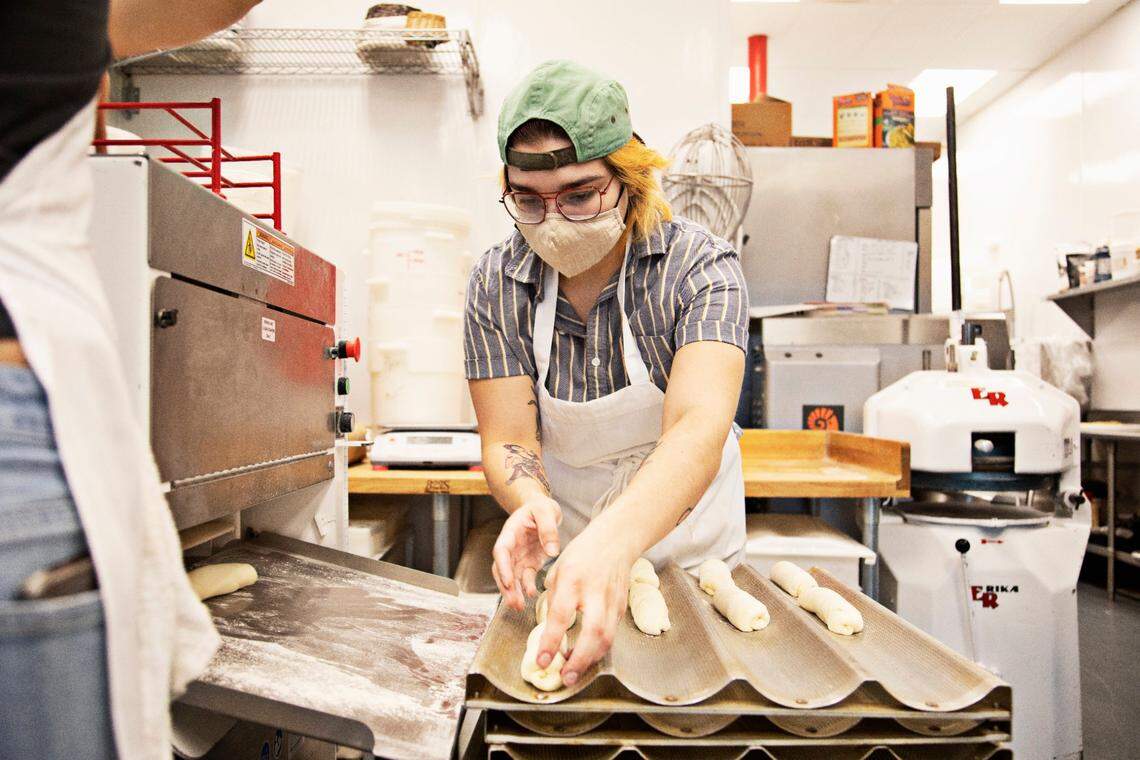 Union Special head baker Maria Luna places brioche loaves to be baked in the kitchen on Thursday morning, March 10, 2022. Luna says they have already seen a price increase for bags of flour.